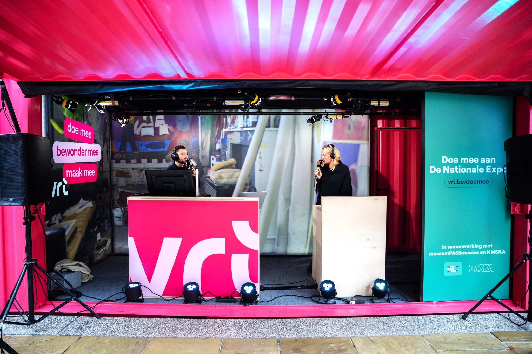 Pink 20 foot new Mobile Radio studio for STUBRU with custom banners, LED lights and speakers in Antwerp city public