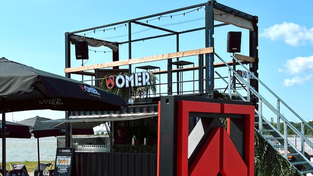 Custom branded 20 foot Omer rooftop bar container for serving of food and drinks at company function in the Port of Antwerp for rent by ContainerID