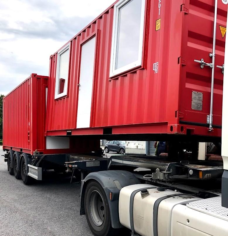 Transportation of two red modified company office shipping container for sale or rent in Antwerp