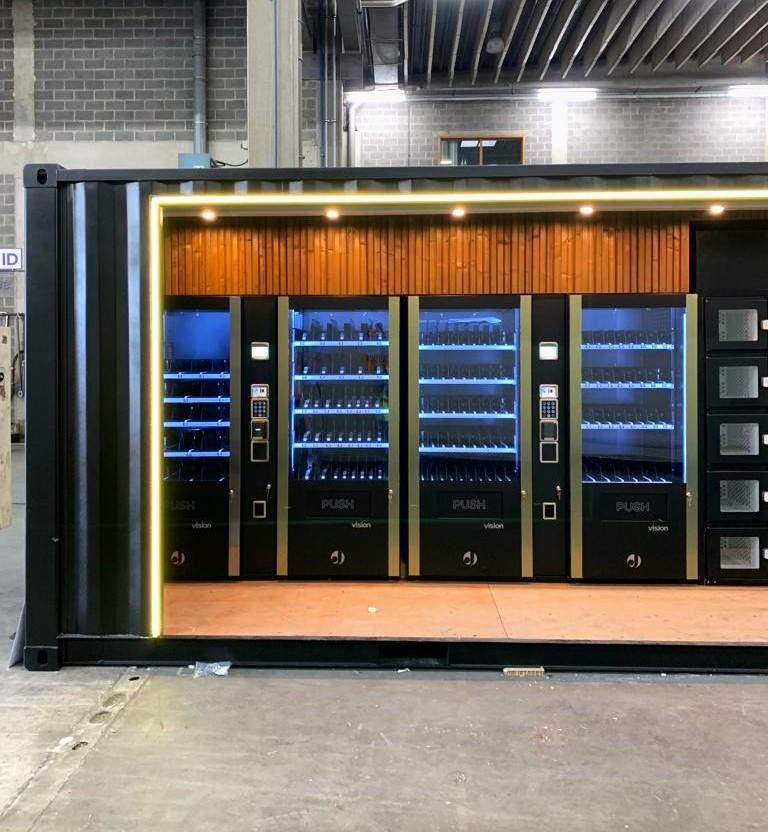 Container conversion into vending machine shop. Black Customised new 20ft container. Equipped with electricity, LED-strip safety camera and an open side. 
