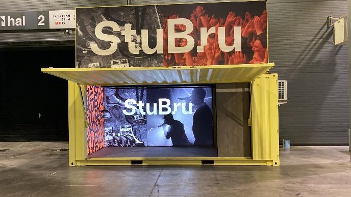 20 foot modified STUBRU yellow radio container with one large opening hatch, custom billboard logo and custom banner advertisement by ContainerID